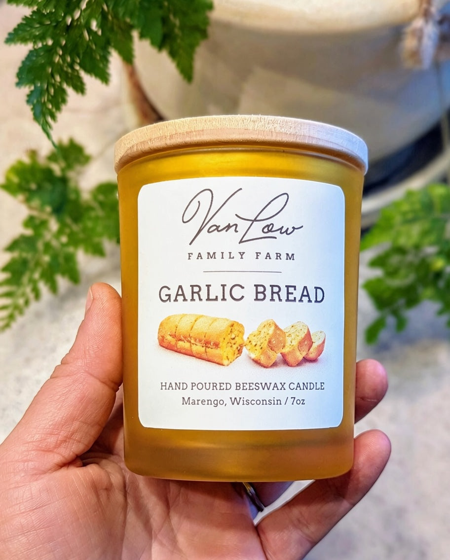Hand holding a Garlic Bread beeswax candle from Van Low Family Farm, Marengo Wisconsin