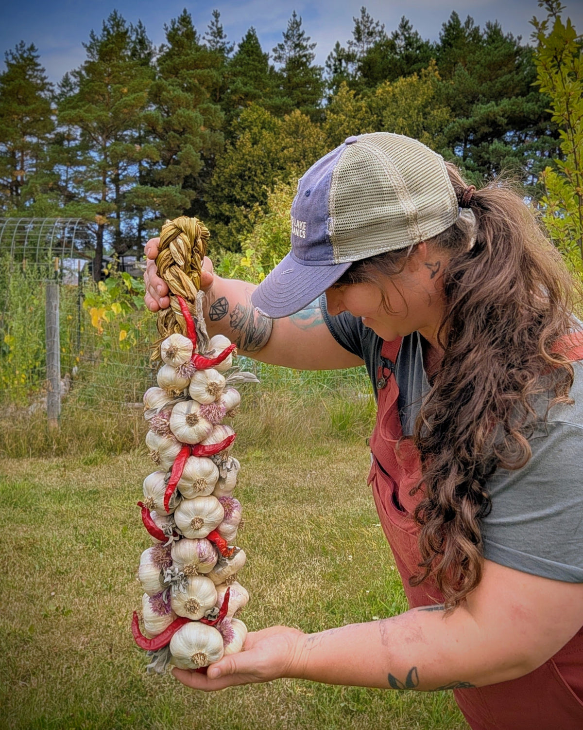 Large pepper and herb garlic braid held outdoors